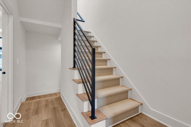 staircase with wood-type flooring