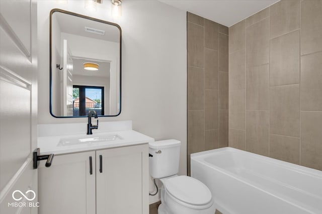 full bathroom featuring toilet, tiled shower / bath combo, and vanity