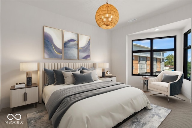 carpeted bedroom with an inviting chandelier