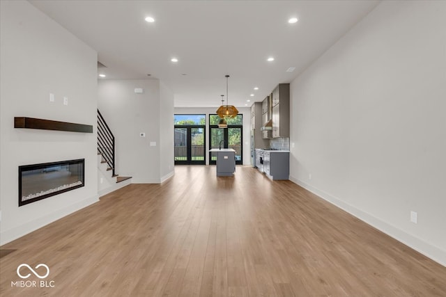 unfurnished living room with light hardwood / wood-style flooring