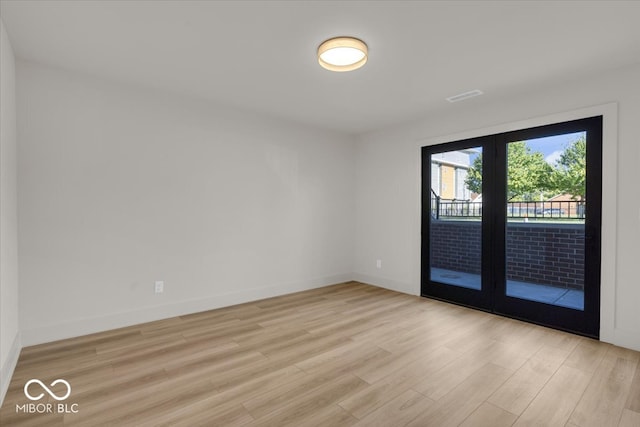 unfurnished room with light hardwood / wood-style flooring