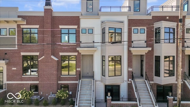 exterior space featuring a balcony and cooling unit