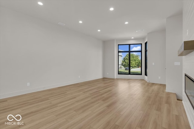 unfurnished living room with light hardwood / wood-style floors