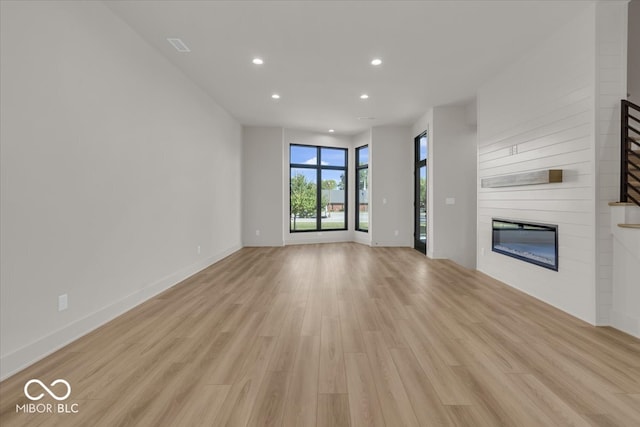 unfurnished living room featuring light hardwood / wood-style floors and a fireplace