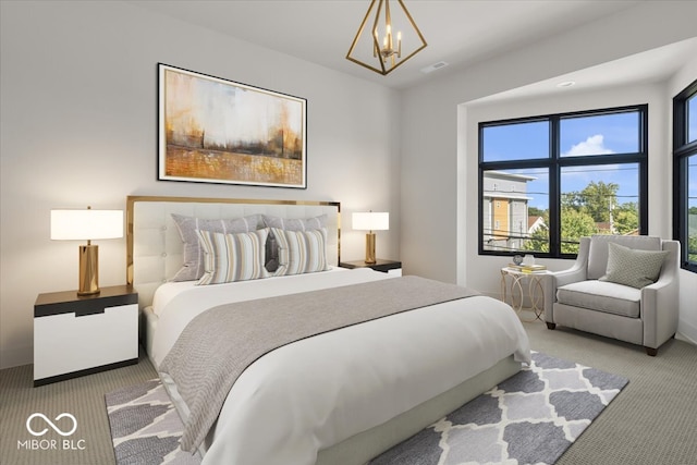 carpeted bedroom featuring a chandelier