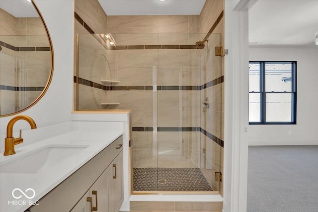 bathroom featuring a shower with door and vanity