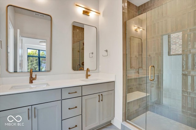 bathroom with vanity and a shower with door