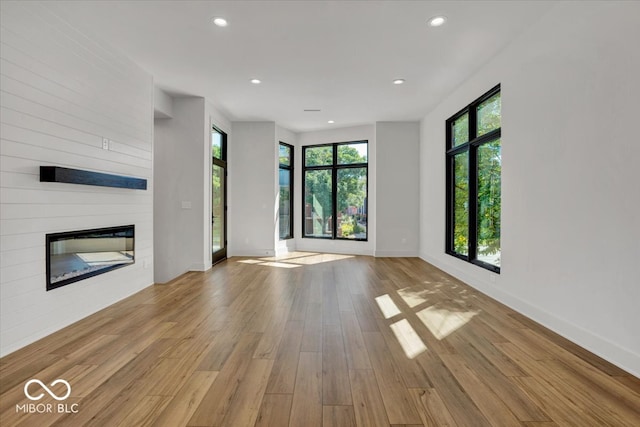 unfurnished living room featuring light hardwood / wood-style floors and a fireplace