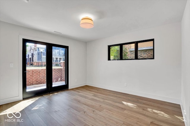 spare room featuring light hardwood / wood-style flooring