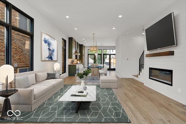 living room featuring light hardwood / wood-style flooring and a fireplace