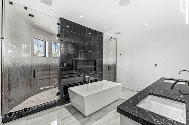 bathroom with double sink vanity, shower with separate bathtub, and tile flooring