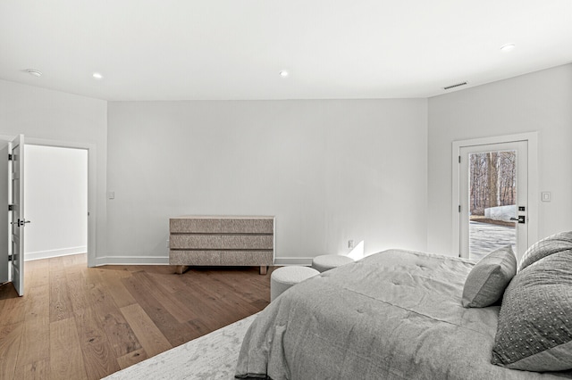 bedroom with hardwood / wood-style flooring