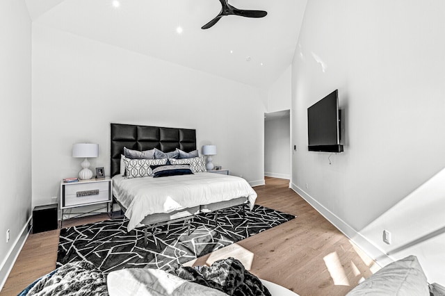 bedroom with high vaulted ceiling, ceiling fan, and dark wood-type flooring