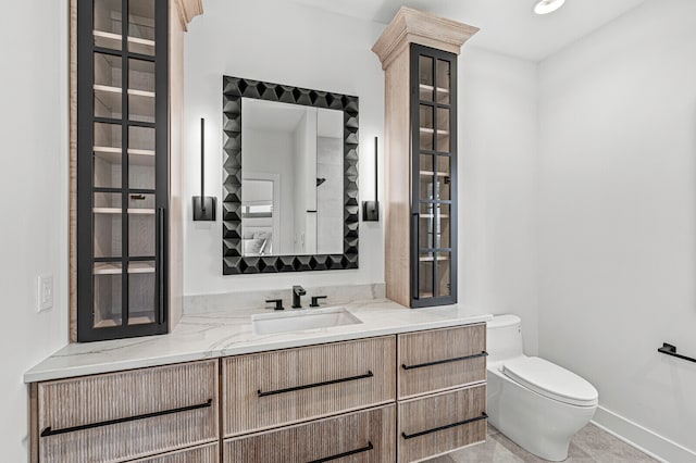 bathroom with vanity, tile flooring, and toilet