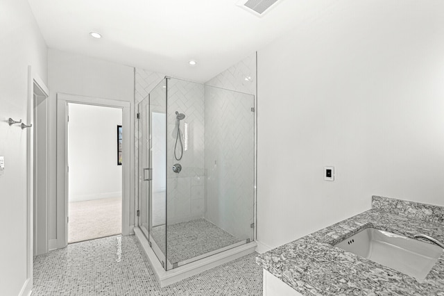 bathroom featuring tile flooring, walk in shower, and vanity