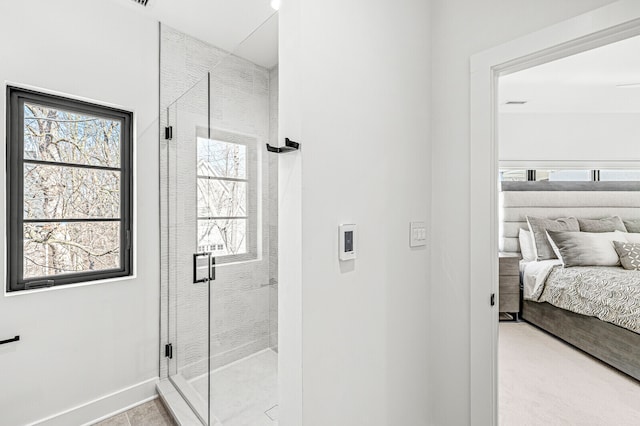 bathroom featuring a shower with shower door