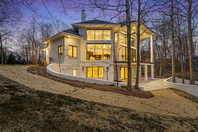 view of back house at dusk