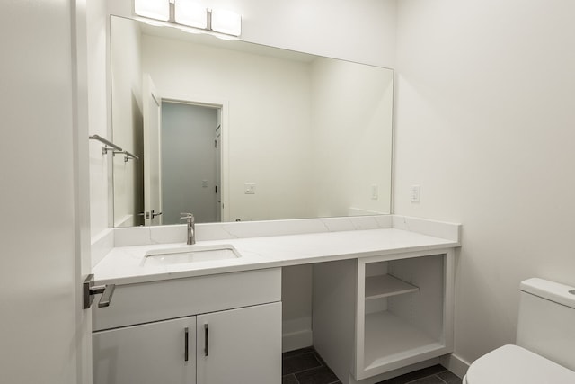 bathroom featuring toilet, tile floors, and vanity