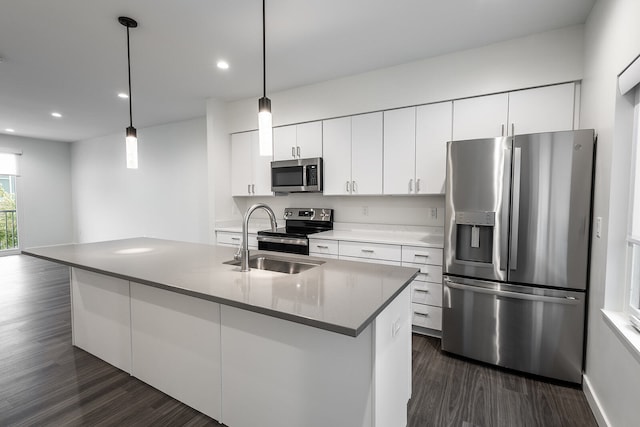 kitchen featuring pendant lighting, stainless steel appliances, dark hardwood / wood-style floors, and white cabinetry