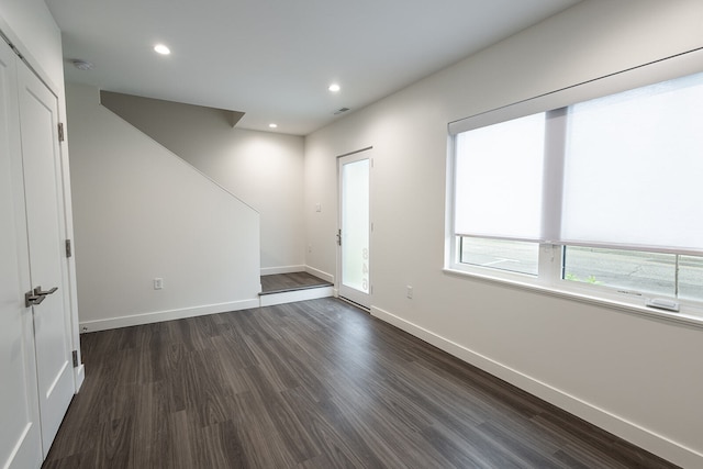 unfurnished room featuring dark hardwood / wood-style flooring