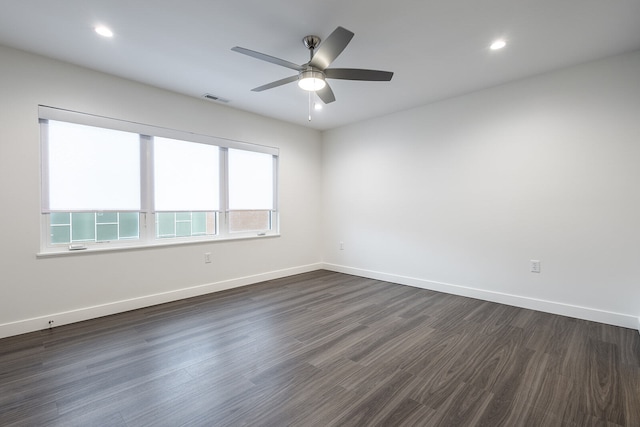 spare room with ceiling fan and dark wood-type flooring