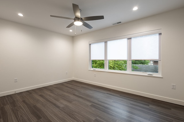 empty room with ceiling fan and dark wood-type flooring