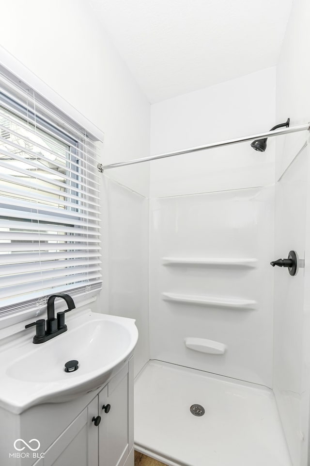 bathroom featuring a shower and sink