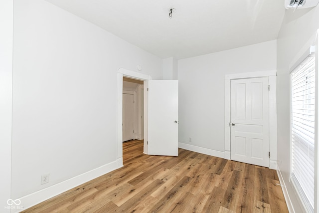 unfurnished bedroom with hardwood / wood-style flooring