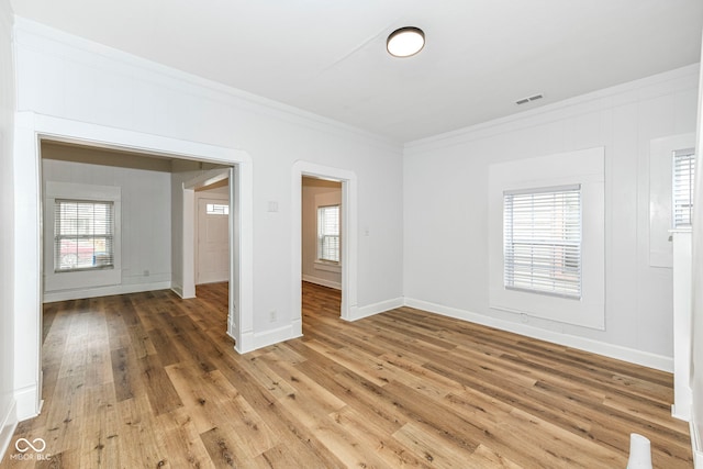 unfurnished room with hardwood / wood-style floors and ornamental molding