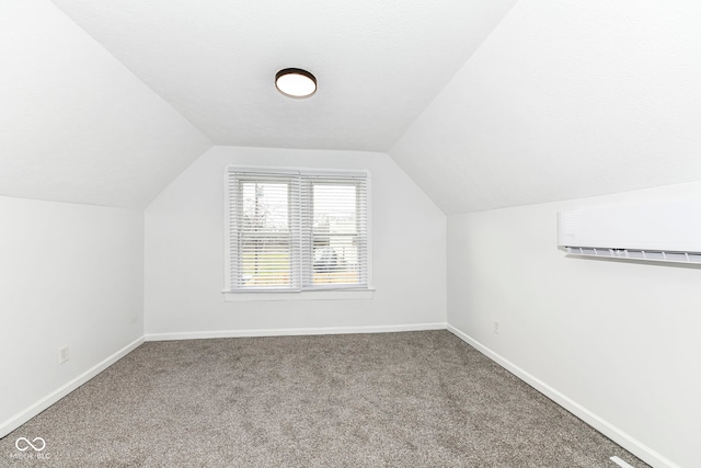 bonus room with lofted ceiling, carpet floors, and a wall unit AC