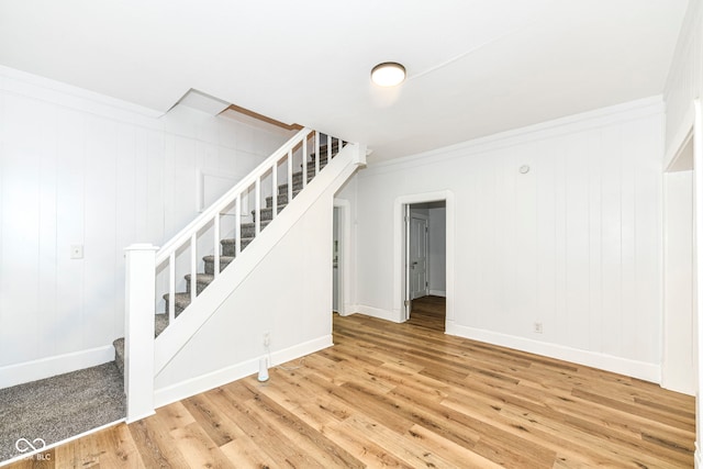 interior space featuring hardwood / wood-style floors and crown molding