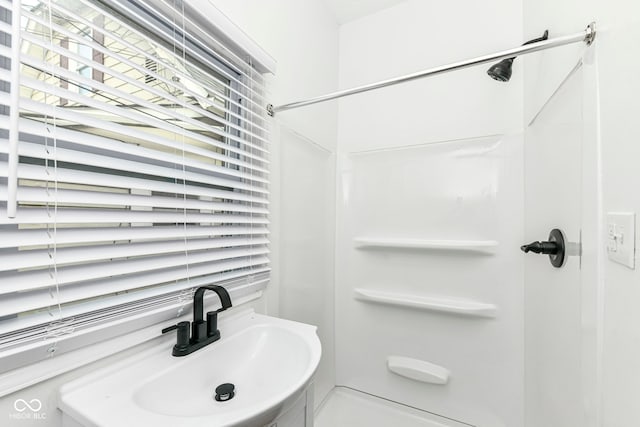 bathroom featuring a shower and sink