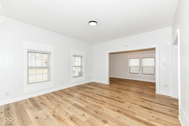 unfurnished room with light wood-type flooring and ornamental molding