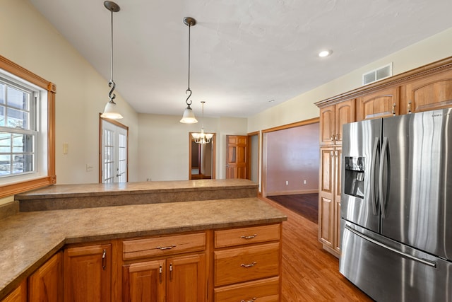 kitchen with decorative light fixtures, a chandelier, french doors, light hardwood / wood-style flooring, and stainless steel refrigerator with ice dispenser