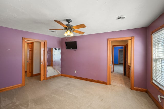 unfurnished bedroom with light carpet and ceiling fan