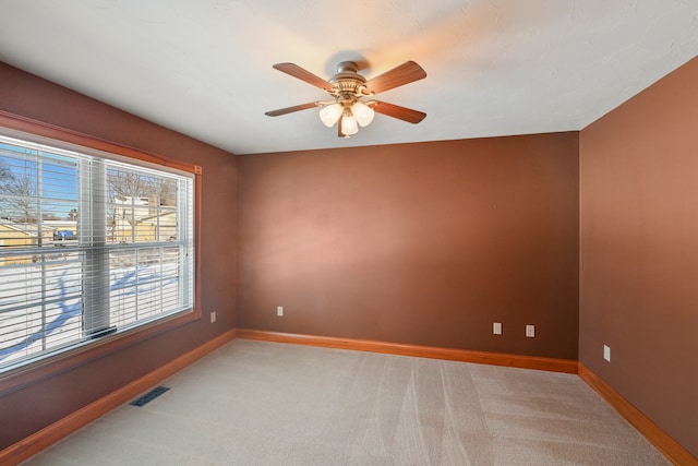 carpeted empty room with ceiling fan