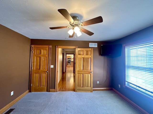 bedroom with dark carpet and ceiling fan