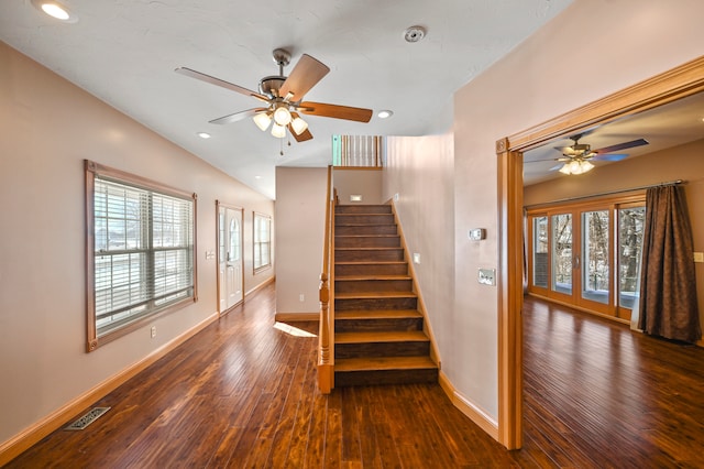 staircase with dark hardwood / wood-style flooring, ceiling fan, and plenty of natural light