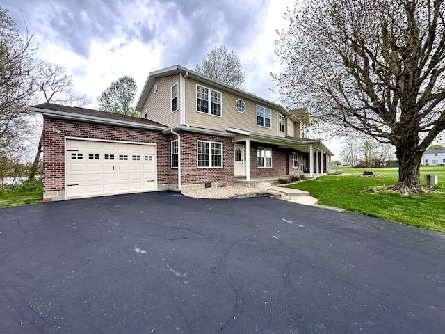 view of front property featuring a front lawn and a garage