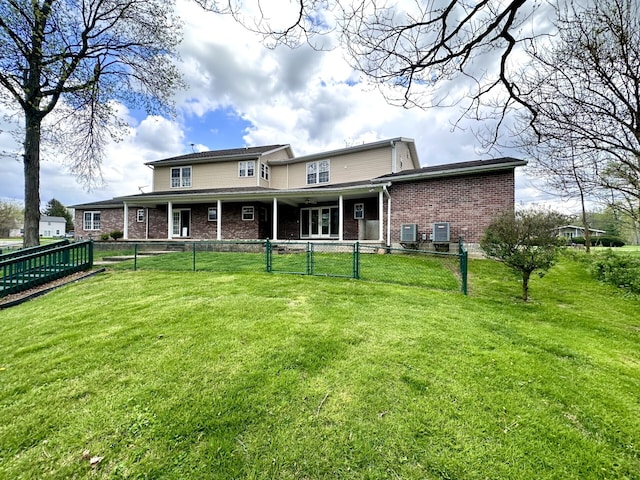 rear view of house featuring a yard