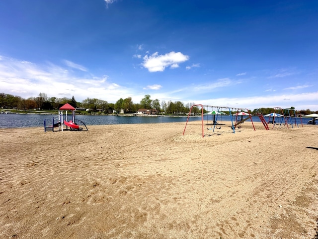 surrounding community with a playground and a water view