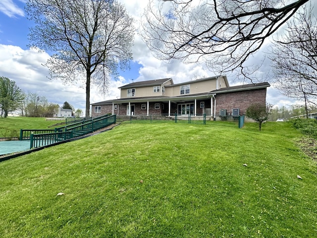 rear view of house featuring a lawn