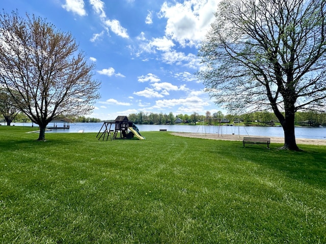 view of yard with a playground and a water view