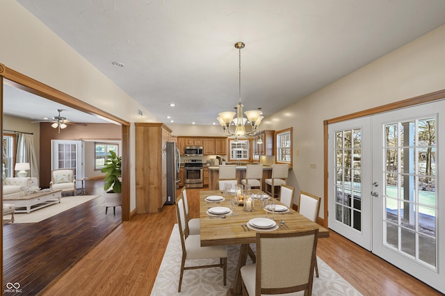 dining area featuring baseboards, light wood-style flooring, french doors, a notable chandelier, and recessed lighting