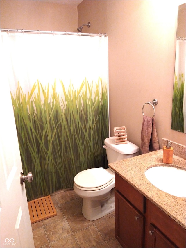 bathroom featuring vanity, toilet, and tile patterned flooring