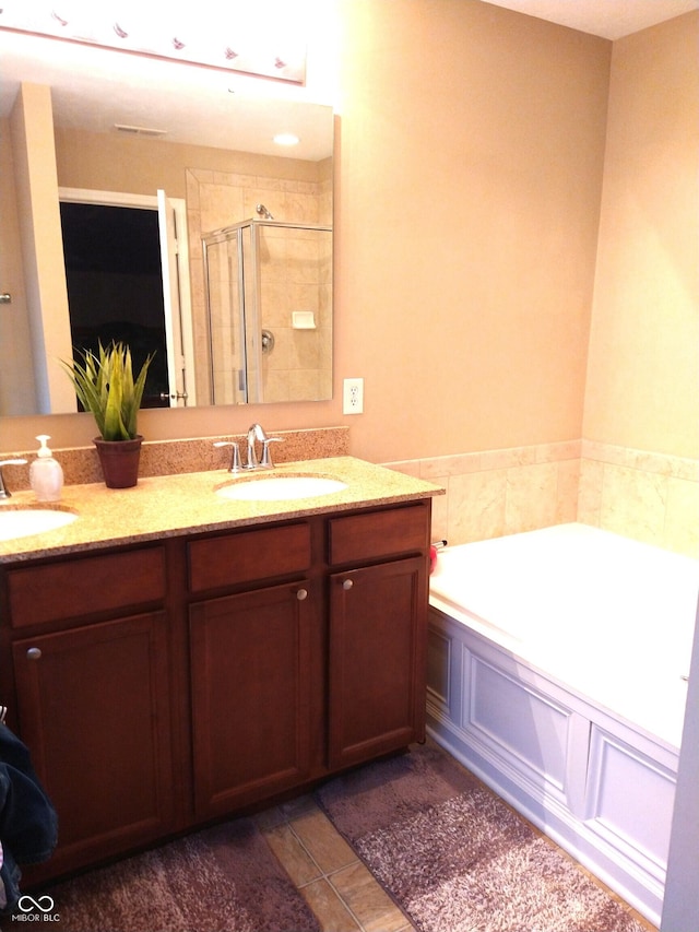 bathroom with vanity, shower with separate bathtub, and tile patterned flooring