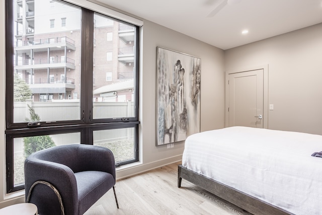 bedroom with light hardwood / wood-style floors and ceiling fan