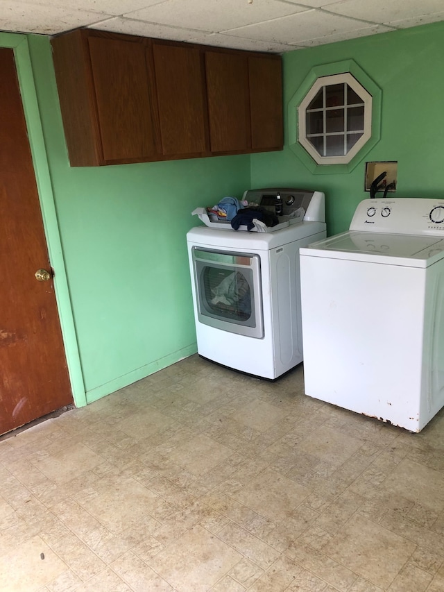 laundry room featuring washer hookup, cabinets, light tile floors, and washer and dryer