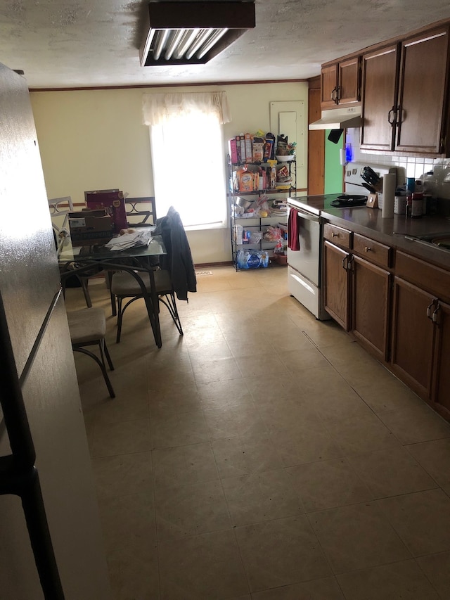 kitchen featuring white range with electric stovetop, tasteful backsplash, and light tile floors