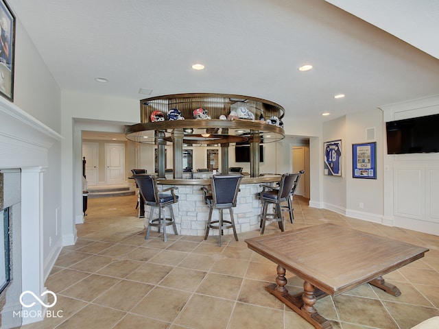 kitchen with light tile patterned floors and a breakfast bar